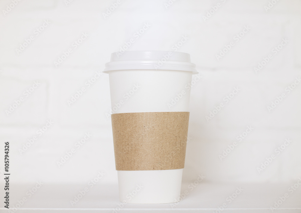 Coffee cup on white brick Coffee cup on white brick