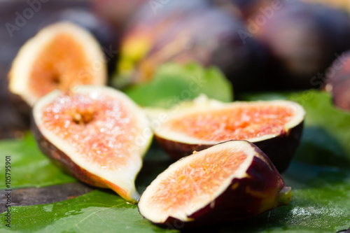 Fresh figs with leaves on stone background