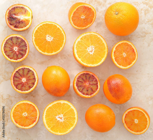 oranges whole and cut in half on a marble background. background