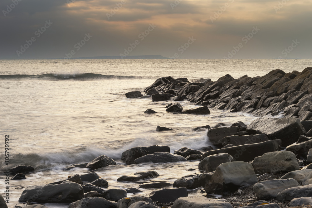 Beautiful sunset landscape image of rocky coastline in Kimmeridg