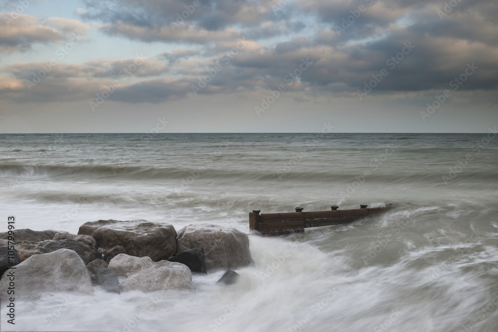 Beautiful long exposure sunset landscape image of pier at sea in Beautiful long exposure sunset landscape image of pier at sea in