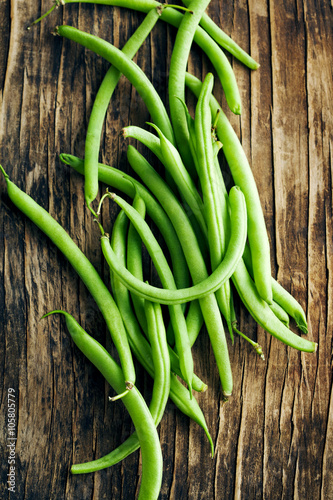 Fresh green beans on wooden background
