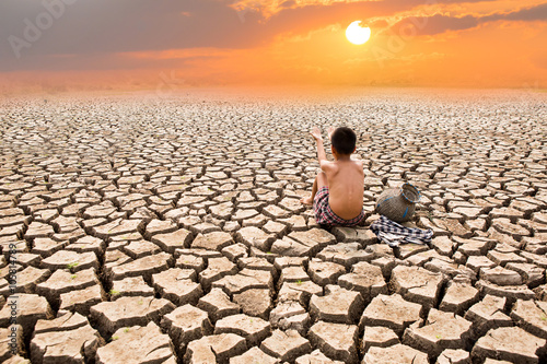Child sit on cracked earth  old man sit on cracked earth in the