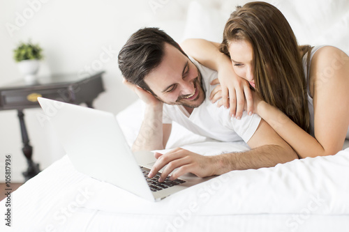 Young couple with laptop in...