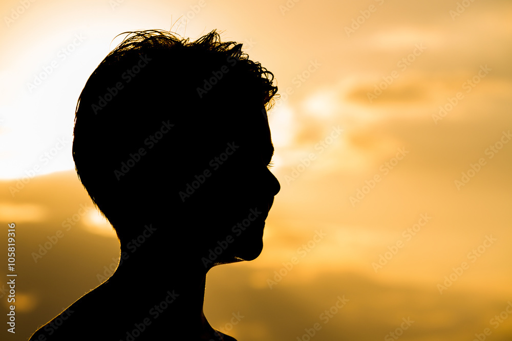 Silhouette happy teenager during sunset Silhouette happy teenager during sunset