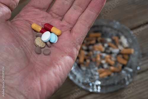 Pills and cigarette buts photo
