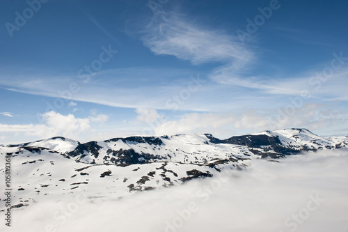 Peaks of mountains above the clouds, mountain Dalsnibba view to Geiranger fjord, Norway