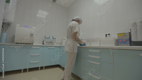 Dental nurse preparing medical instruments
