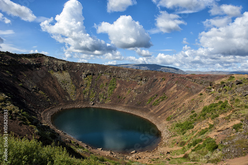 Volcanic crater Kerid with blue lake inside, at sunny day with beautiful sky, Iceland