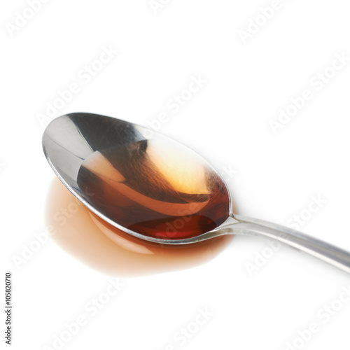 Steel spoon in a puddle of wine vinegar
