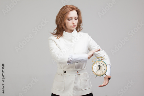 Attractive businesswoman showing clock
