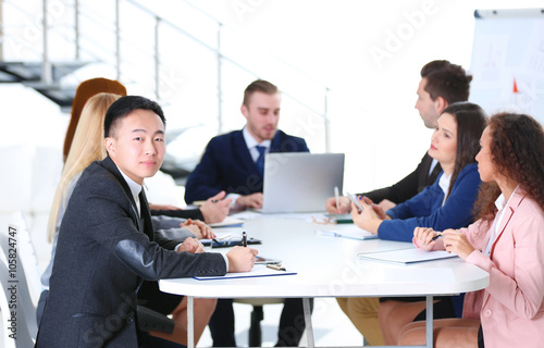 Young colleagues sitting at the business meeting in the office