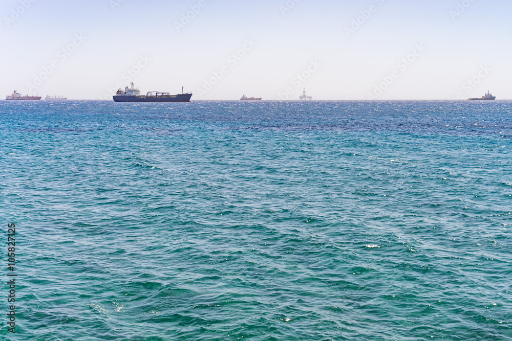 Mediterranean Sea with distant view on several ships and oil platform on horizon. Limassol, Cyprus.
Mediterranean Sea with distant view on several ships and oil platform on horizon. Limassol, Cyprus.