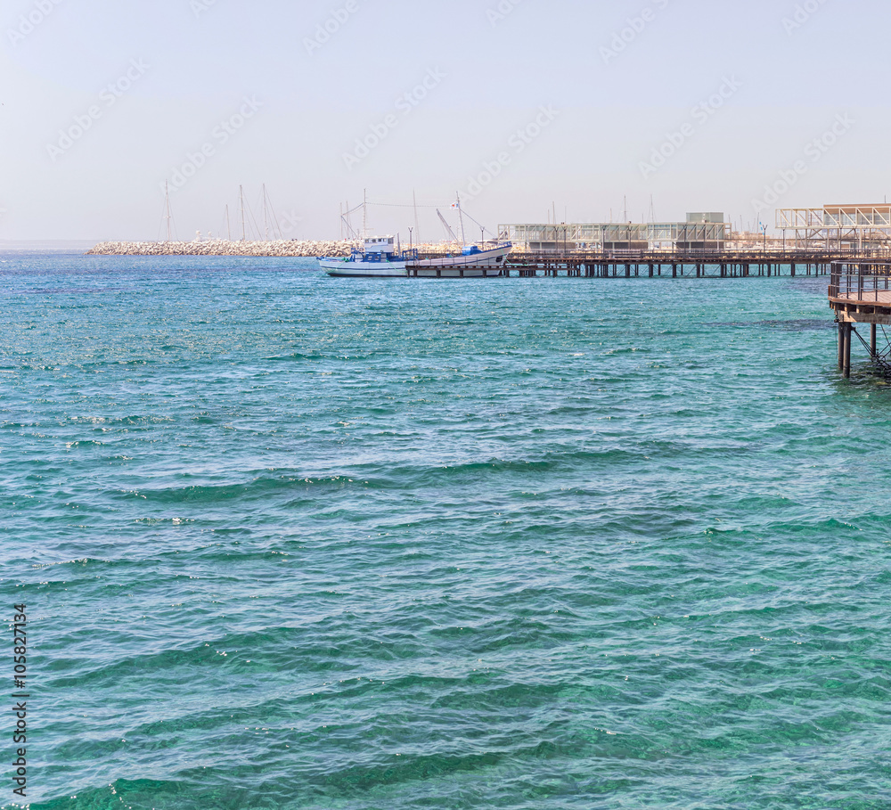 White ship moored at pier on Mediterranean Sea horizon. Limassol, Cyprus.
