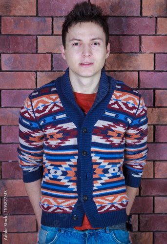 young handsome guy standing near a brick wall © nazarets