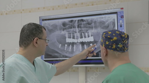 Closeup of two doctors with x-ray prints 