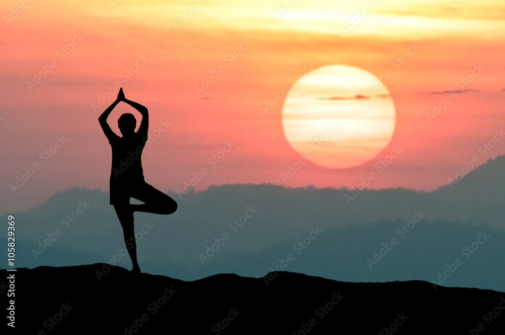 Silhouette Yoga practitioner during the twilight sunset meditation with Omega sunset or Inferior-Mirage Sunset