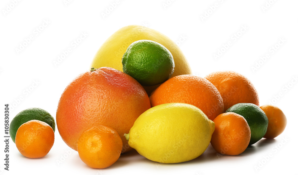 A heap of mixed citrus fruit including a grapefruit, oranges, lemons, clementines, tangerines, limes and a pomelo fruit isolated on a white background, close up A heap of mixed citrus fruit including a grapefruit, oranges, lemons, clementines, tangerines, limes and a pomelo fruit isolated on a white background, close up