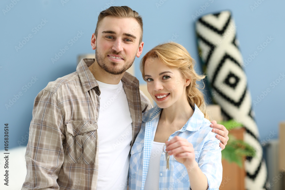 Young happy couple holding keys from their new apartment Young happy couple holding keys from their new apartment