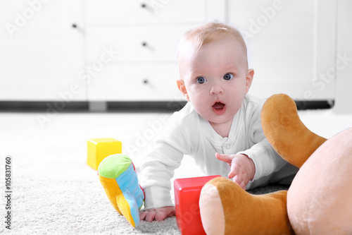 Cute baby boy playing with ...