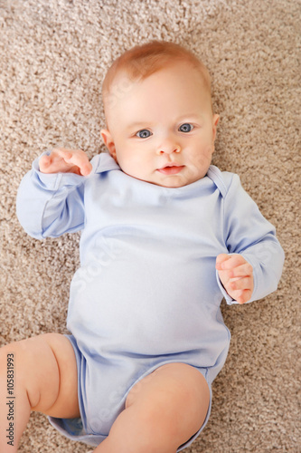 Cute baby lying on the floo...