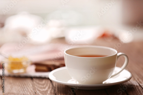 Cup of tea on light blurred background