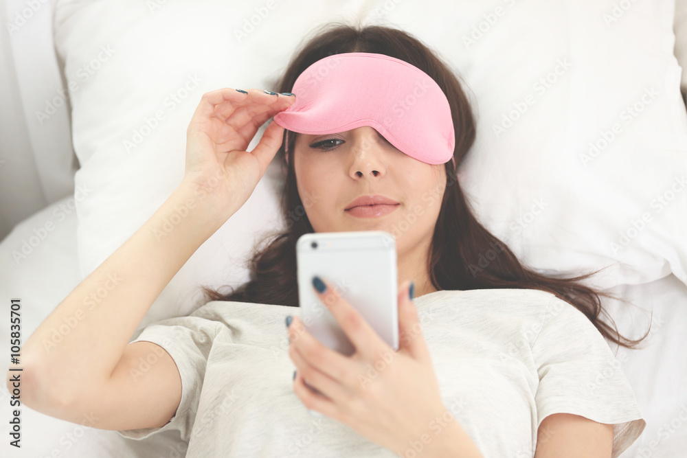 Beautiful girl lying with an eye mask in the bedroom. Beautiful girl lying with an eye mask in the bedroom.