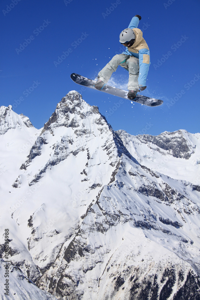 Flying snowboarder on mountains. Extreme sport. Flying snowboarder on mountains. Extreme sport.