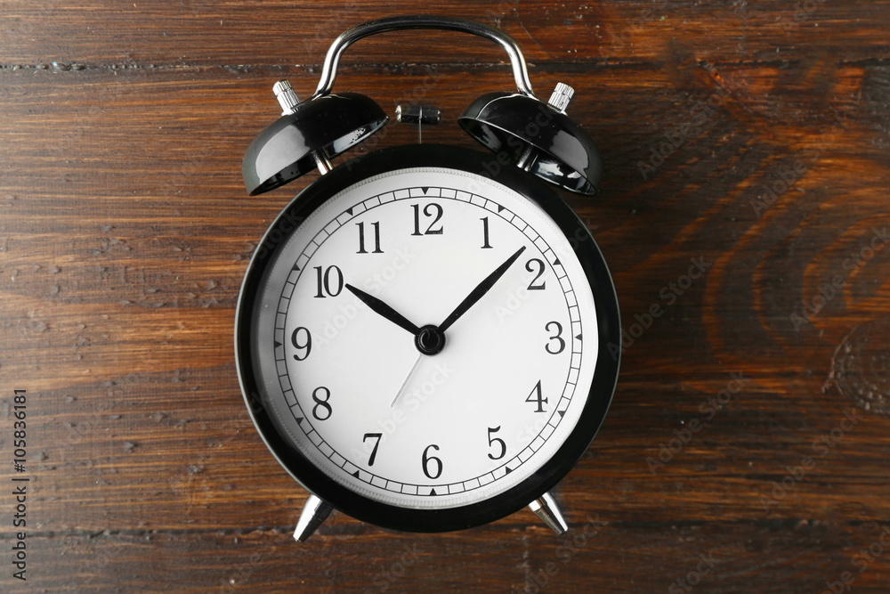 Alarm clock on old wooden table. Alarm clock on old wooden table.