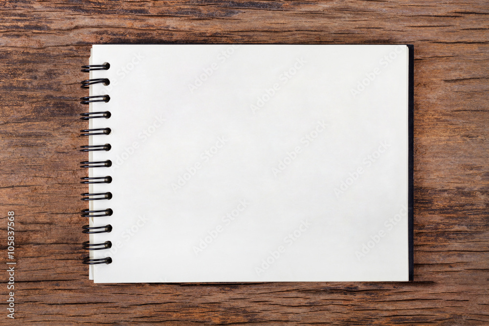 Blank empty notepad on wood background Blank empty notepad on wood background