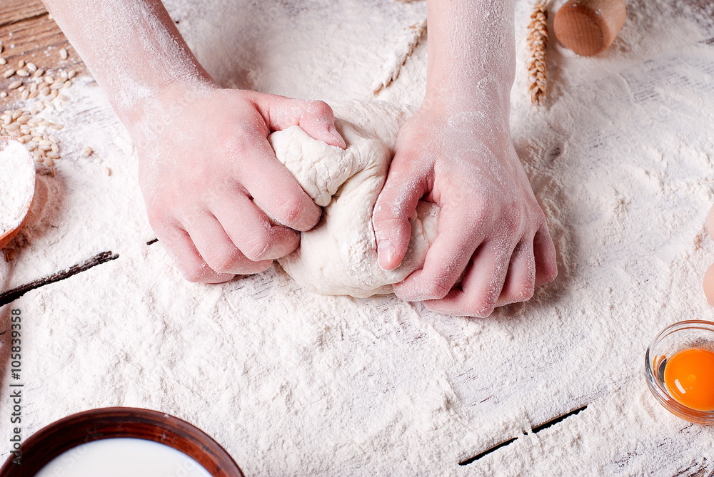 Fototapeta premium women's hands knead the dough