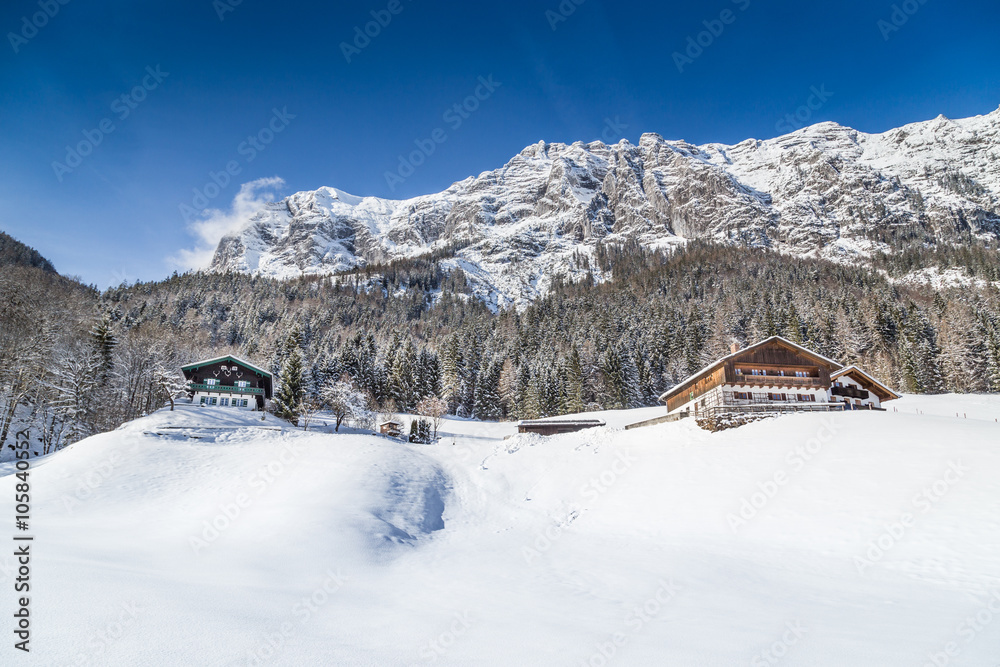 Winter wonderland in the Alps with traditional farm houses