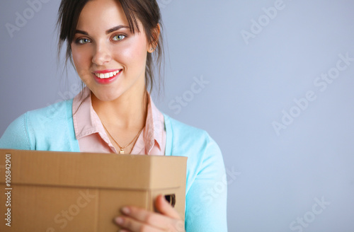 Portrait of pretty woman holding a box 