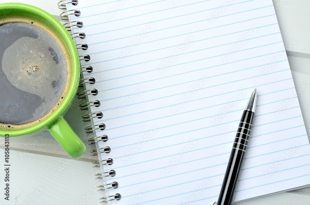 Cup of coffe with notebook and pen Cup of coffe with notebook and pen