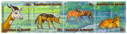 REPUBLICA BURUNDI - CIRCA 1976: A stamp printed in Republica Burundi shows african animals gazella dama, canis mesomelas, tragelaphus spekei, Cephalophus zebra, circa 1976 photo