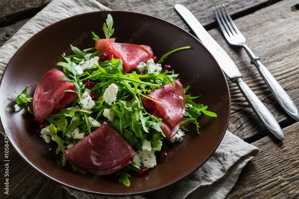 Delicious salad with arugula, cheese and dried beef Delicious salad with arugula, cheese and dried beef
