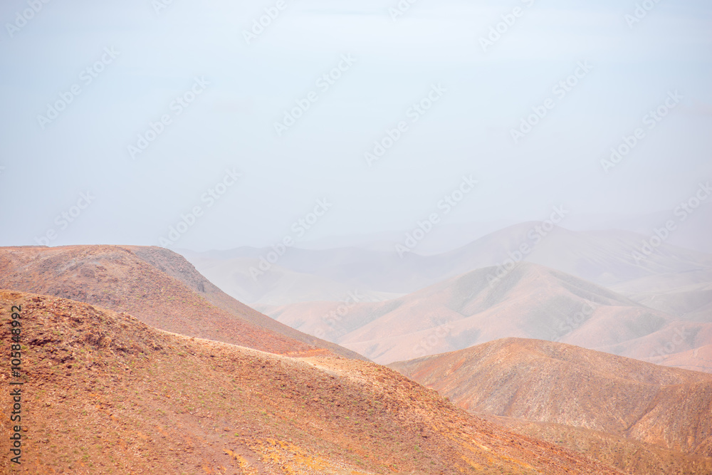 Fototapeta premium Mountain landscape at the central part of Fuerteventura island on the cloudy and foggy weather in Spain