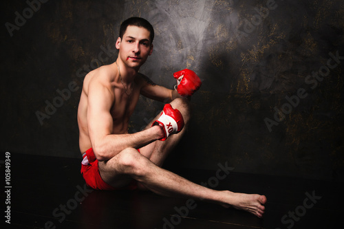 Boxer with red gloves in dark room © ribalka yuli