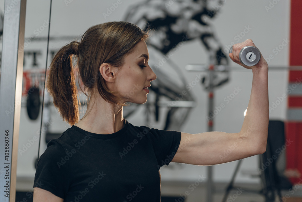 Beautiful girl in the gym with weights Beautiful girl in the gym with weights