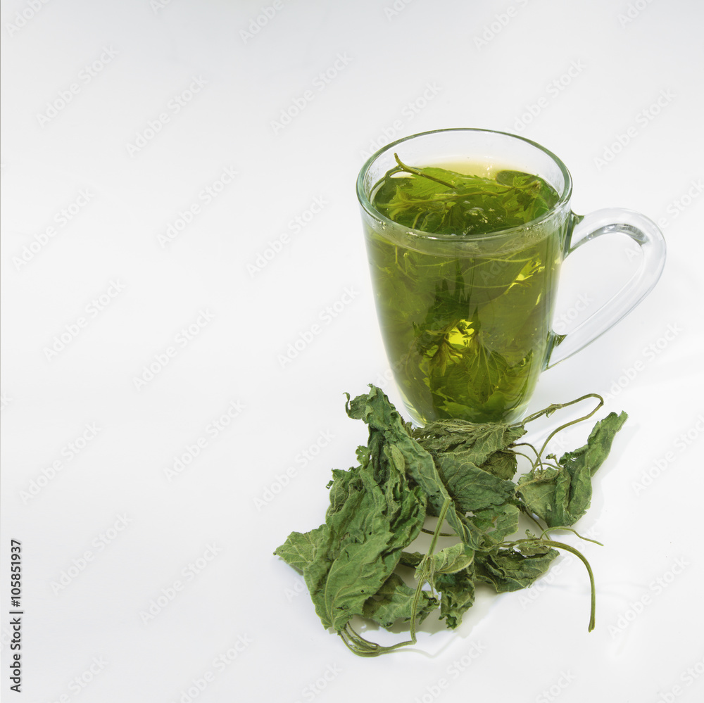 Tea glass with dried nettle tea Tea glass with dried nettle tea
