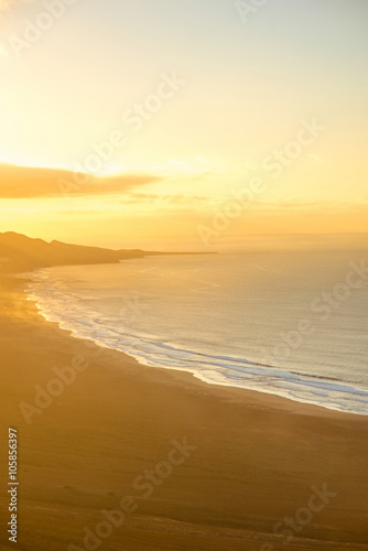 Top view on Cofete beach and mountains on Jandia peninsula on Fuerteventura island on the sunset in Spain