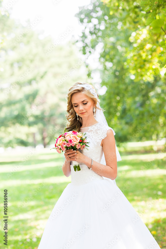 Beautiful bride outdoors in a park.