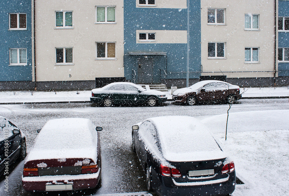 four cars near the house in the snow