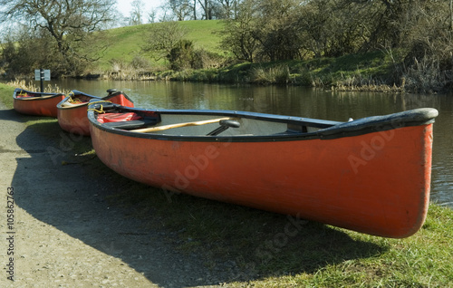 red canoes on canal bank
