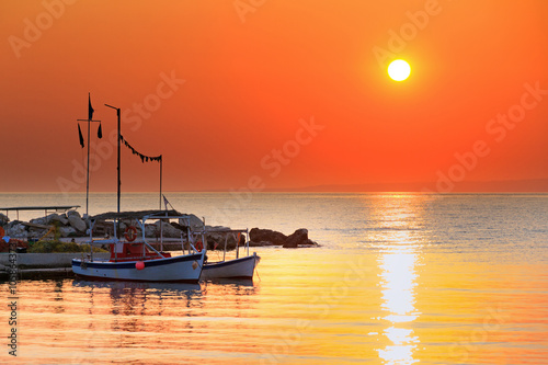 Beautiful sunrise in the little harbor of planos on the island of Zakynthos, Greece photo