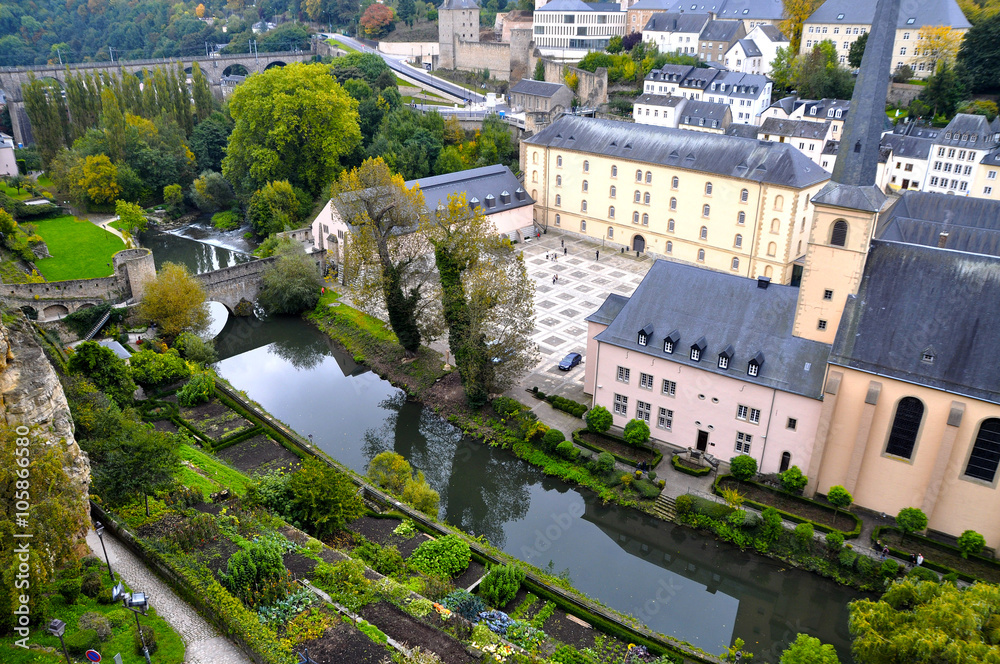 Arial view of Grund district of Luxembourg City seen with Neumuenster Abbey and Alzette river