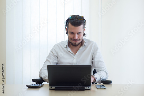 angry businessman with laptop