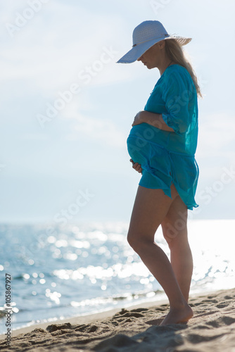 Beautiful pregnant woman on beach 