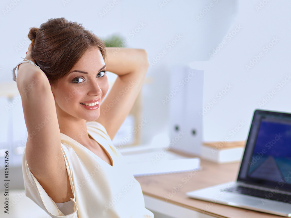 Business woman relaxing with hands behind her head and sitting on an office chair Business woman relaxing with hands behind her head and sitting on an office chair