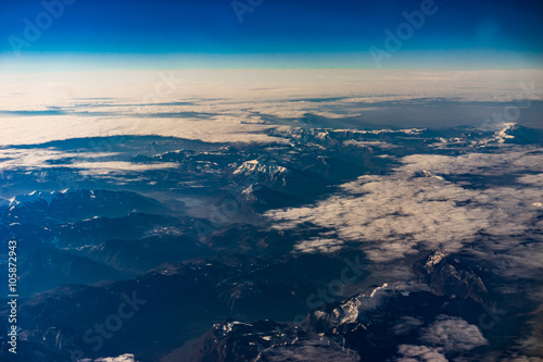 Mountains in winter during sunrise from the air - Alps